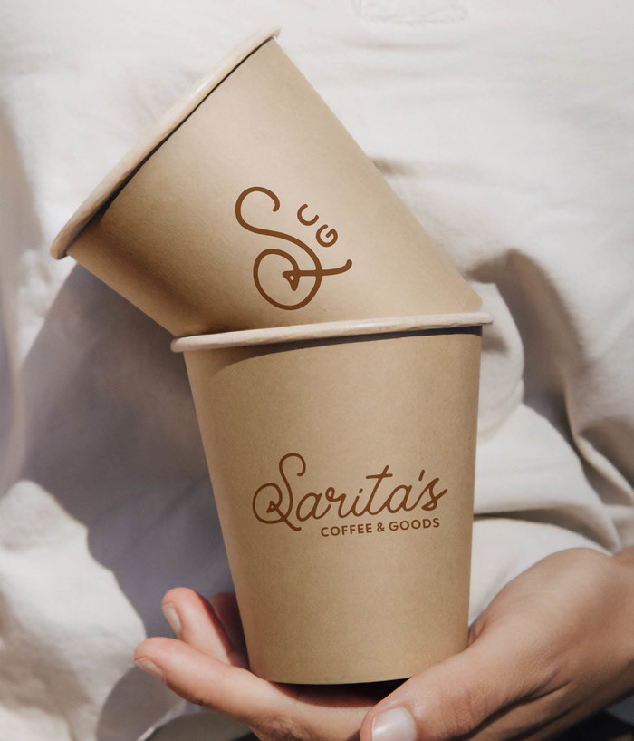 Kraft coffee cups with the full Sarita's logo and shortform logo