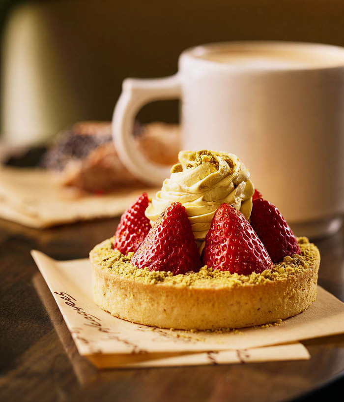 Strawberry pastry sitting on branded kraft paper.