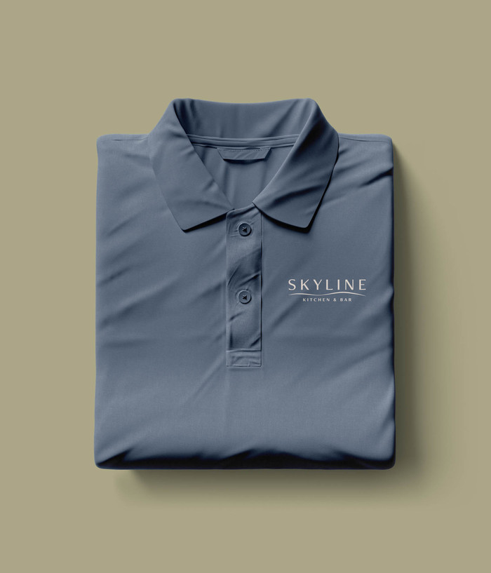 Blue colored polo embroidered with the Skyline Kitchen and Bar logo.