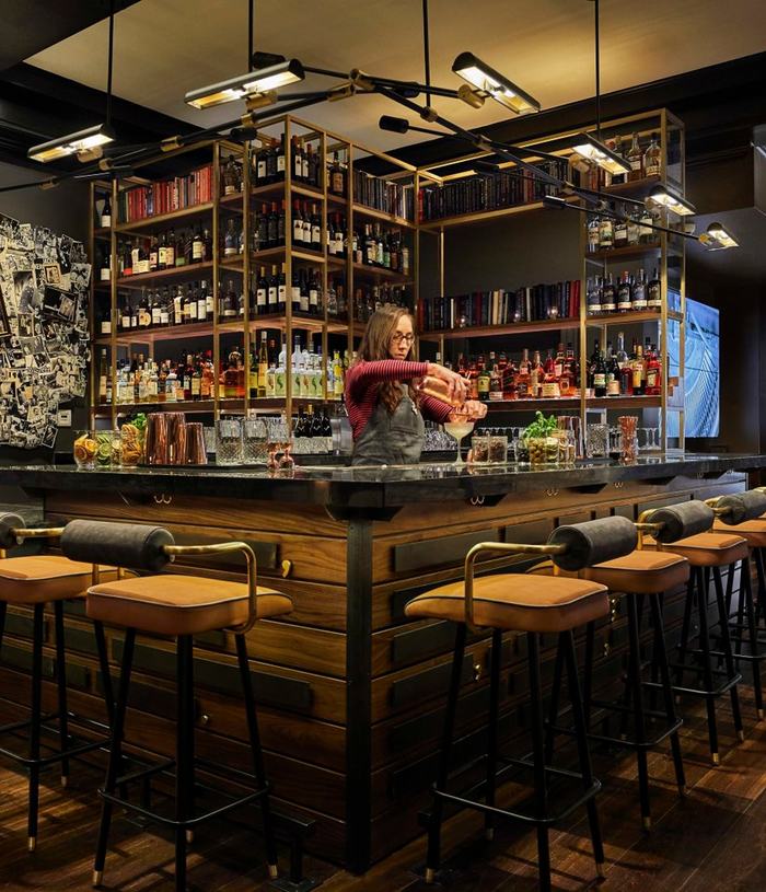 A bartender makes a cocktail at the bar inside Obscenity Bar & Lounge