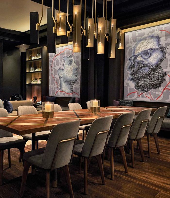 Community space inside Obscenity Bar & Lounge with art pieces of beat poets on the wall