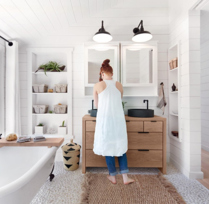 Woman standing at bathroom sink washing hands