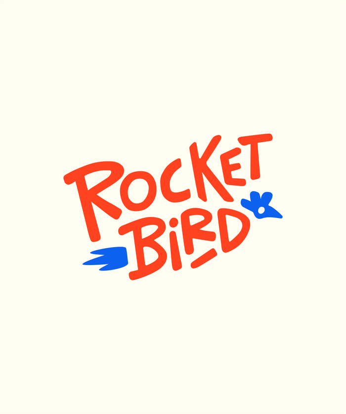 Primary rocketbird logo, orange type with blue glyphs on cream background